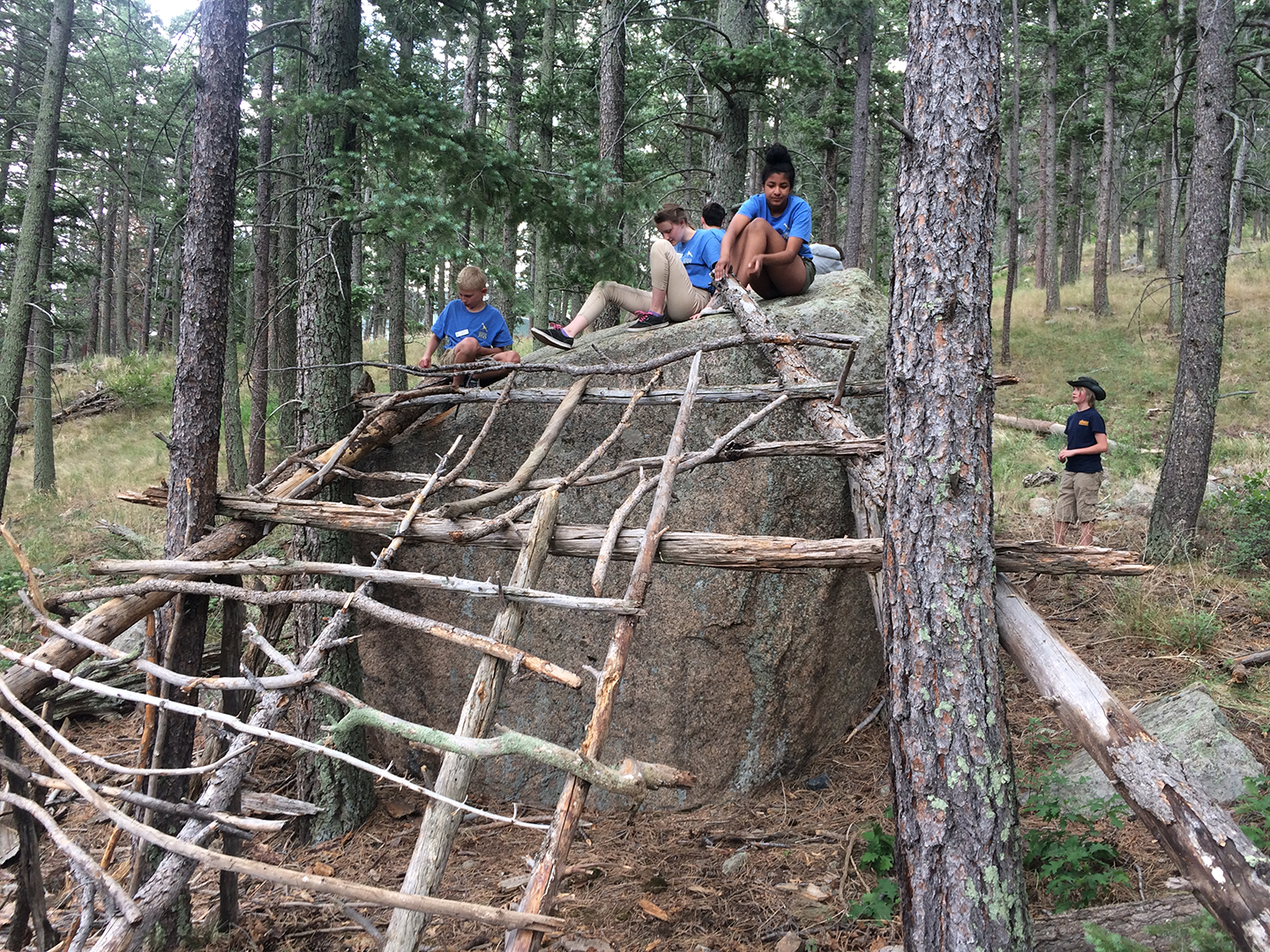 Outdoor School program building a fort in the woods
