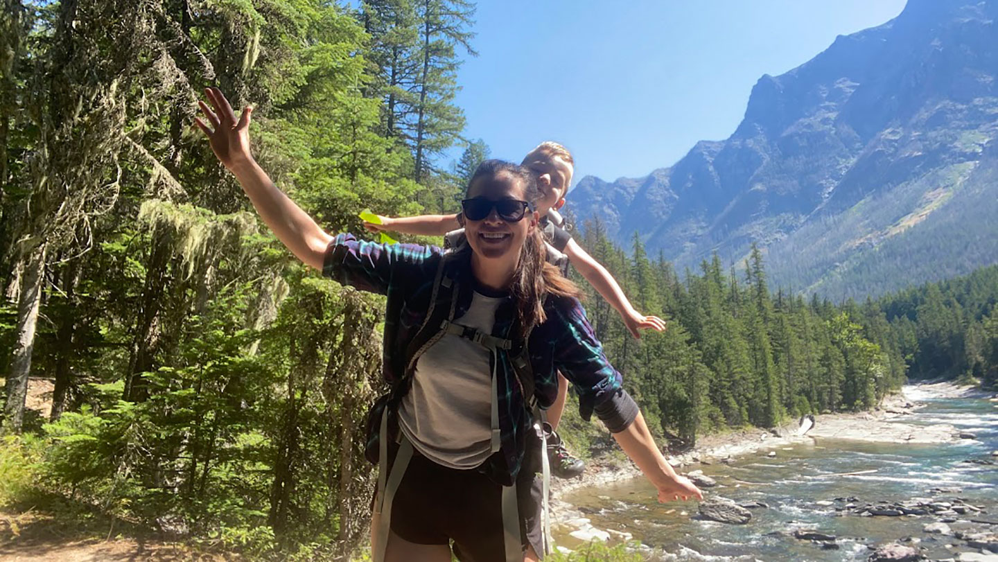 Toddler trekking with adult piggy-back in the outdoors