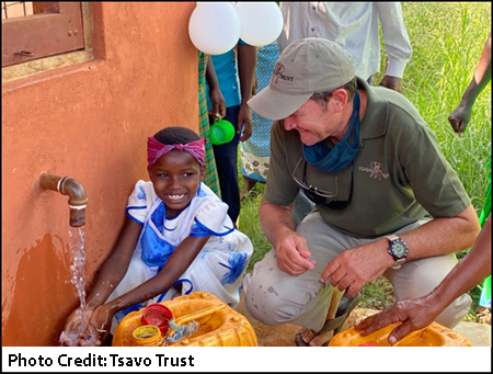 Richard Moller with community member of new water borehole