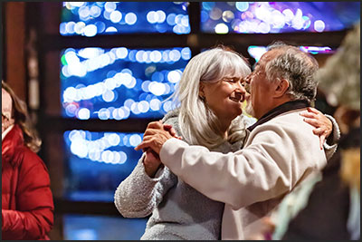 Couple dancing at Electric Moonlight evening holiday adult 21+ event at Cheyenne Mountain Zoo