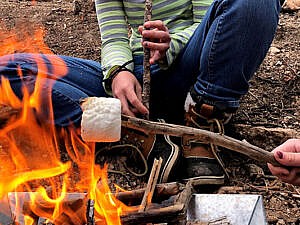 Teen Starlight Safari roasting marshmallows